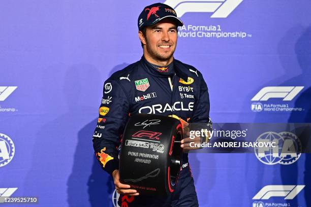 Red Bull's Mexican driver Sergio Perez poses for a picture with the Pole Position award after the qualifying session on the eve of the 2022 Saudi...