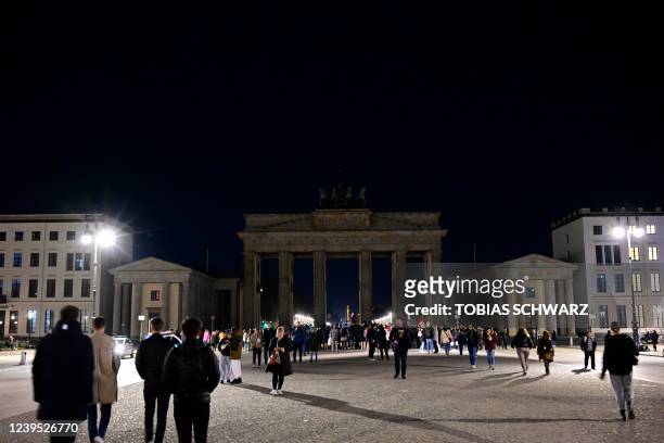 Erlin's Brandenburg Gate is pictured as its illumination turned off on the occasion of the Earth Hour, on March 26, 2022. - Earth Hour, organized by...