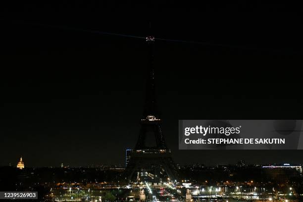 This illustration picture shows the Eiffel Tower in Paris after it was switched off as part of the Earth Hour environmental campaign, on March 26,...