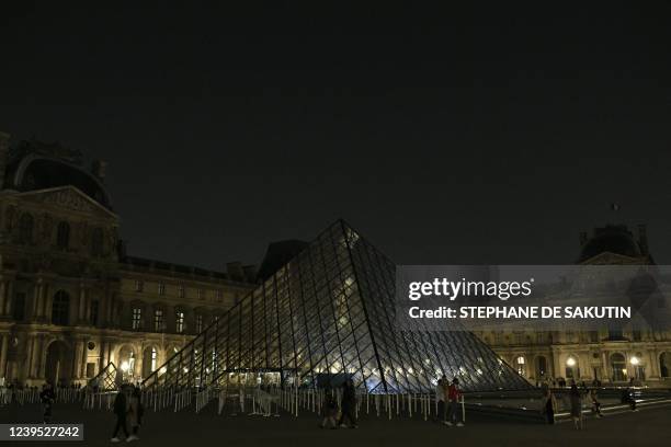 This illustration picture shows the Pyramide du Louvre, designed by Ieoh Ming Pei, in Paris after it was switched off as part of the Earth Hour...