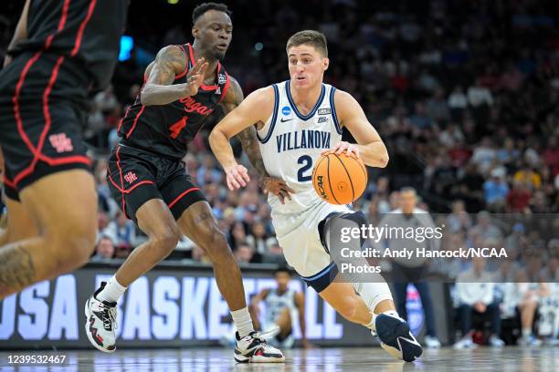 Collin Gillespie of the Villanova Wildcats dribbles the ball past Taze Moore of the Houston Cougars during the Elite Eight round of the 2022 NCAA...