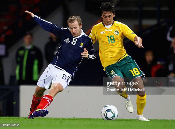 Barry Bannan of Scotland tackles Deividas Cesnauskis of Lithuania during the UEFA EURO 2012 Group I qualifying match between Scotland and Lithuania...