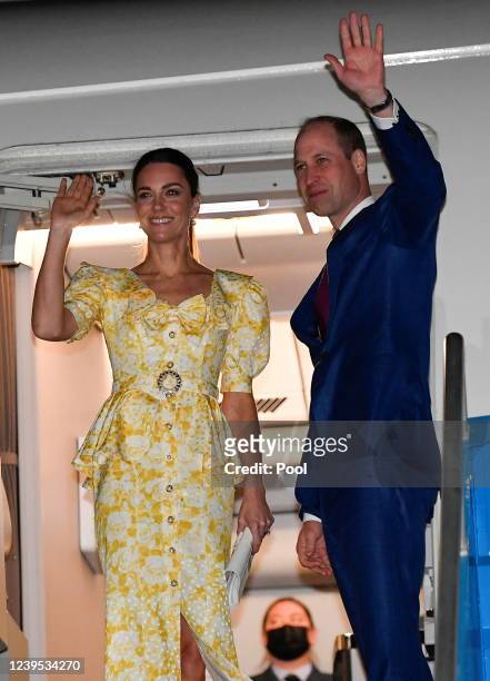 Catherine, Duchess of Cambridge and Prince William, Duke of Cambridge wave from their aircraft during the departure ceremony at Lynden Pindling...