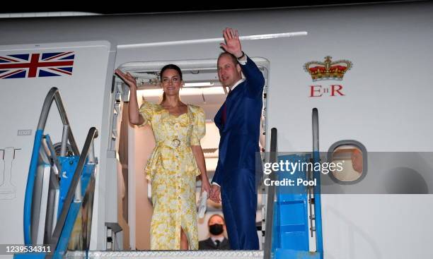 Catherine, Duchess of Cambridge and Prince William, Duke of Cambridge wave from their aircraft during the departure ceremony at Lynden Pindling...