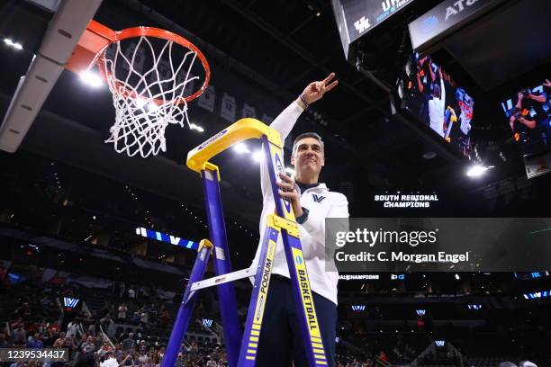 Head coach Jay Wright of the Villanova Wildcats cuts down the net after winning in the Elite Eight round of the 2022 NCAA Mens Basketball Tournament...