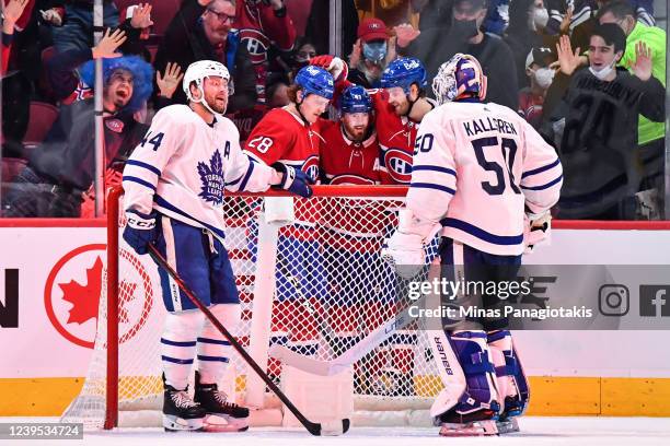 Paul Byron of the Montreal Canadiens celebrates his goal with teammates Christian Dvorak and Joel Armia as Morgan Rielly of the Toronto Maple Leafs...