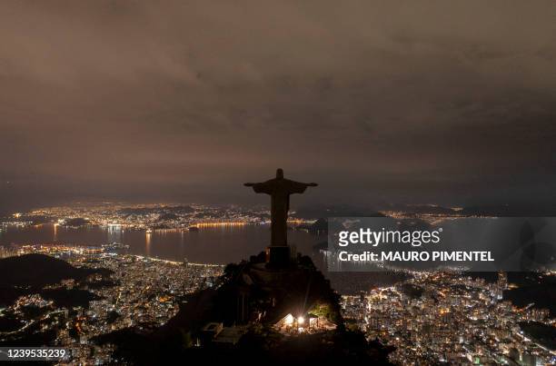 The statue of Christ the Redeemer is seen after being plunged into darkness for the Earth Hour environmental campaign on top of Corcovado hill in Rio...