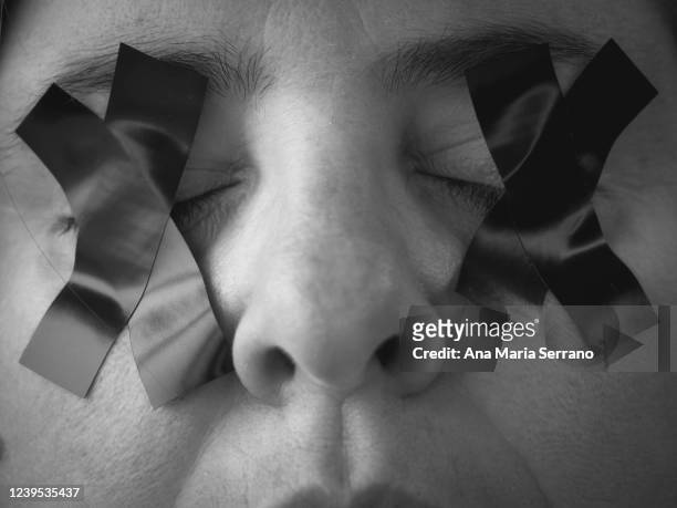 portrait of a woman with an x of duct tape covering her eyes - redacted stock pictures, royalty-free photos & images