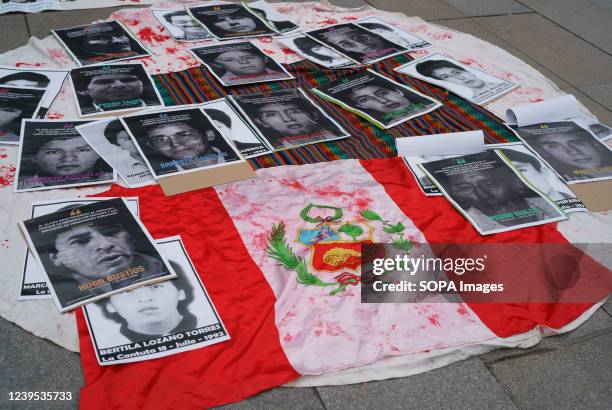Flag of Peru next to photographs of supposedly assassinated during the mandate of Fujimori during a protest. Protest against the decision of the...
