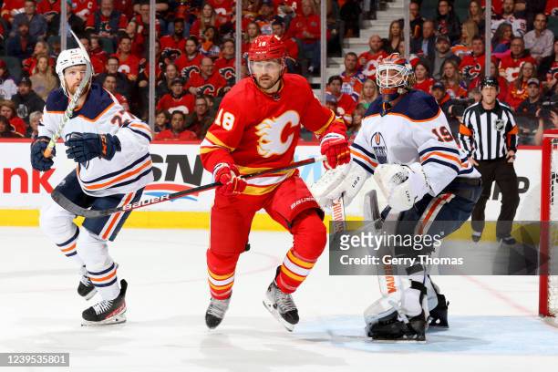 Ryan Carpenter of the Calgary Flames skates against Brett Kulak of the Edmonton Oilers at Scotiabank Saddledome on March 26, 2022 in Calgary, Alberta.