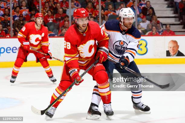 Elias Lindholm of the Calgary Flames skates against Duncan Keith of the Edmonton Oilers at Scotiabank Saddledome on March 26, 2022 in Calgary,...
