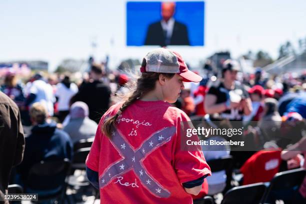 An attendee wears a Confederate battle flag shirt with "Georgia is Red" written on it at a Georgia state Republican campaign event headlined by...