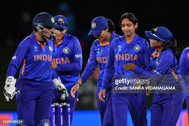 India's Harmanpreet Kaur is congratulated by teammate Rajeshwari Gayakwad after taking the wicket of South Africa's Sune Luus during the Women's...