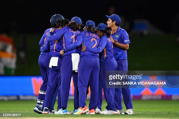 Indian team huddle during the Women's Cricket World Cup match between South Africa and India at Hagley Oval in Christchurch on March 27, 2022.