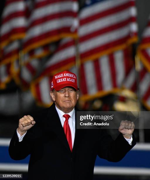 Former US President Donald Trump is seen with a red hat during a rally sponsored by Save America with David Perdue, Burt Jones, Herschel Walker,...