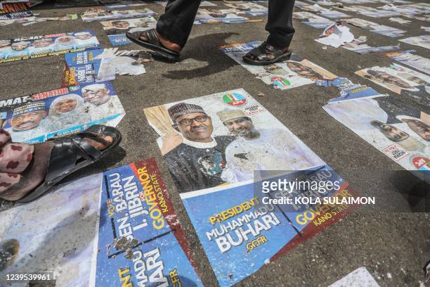 Delegates of Nigerias ruling political party, the All Progressive Congress, walk on posters at the Eagles Square, venue of the partys National...