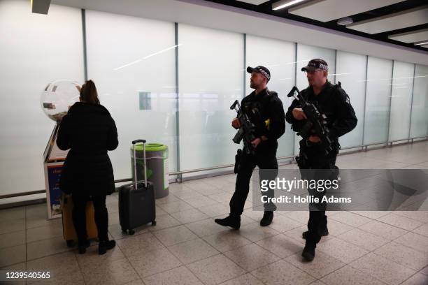Armed police officers at Gatwick Airport on March 27, 2022 in London, England. Gatwick's South terminal closed in June 2020 to reduce costs during...