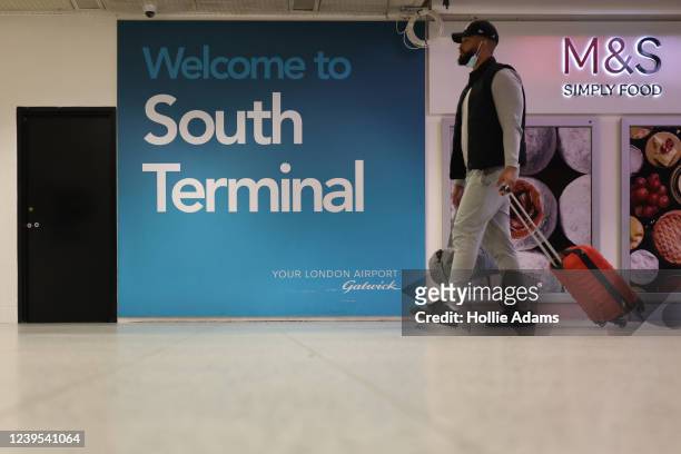 Traveler at Gatwick Airport on March 27, 2022 in London, England. Gatwick's South terminal closed in June 2020 to reduce costs during the Coronvirus...
