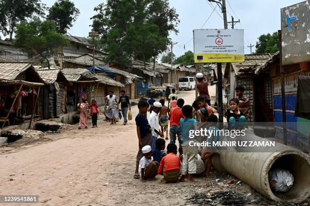 Rohingya refugee children play along a street in Kutupalong refugee camp in Ukhia, on March 27, 2022.