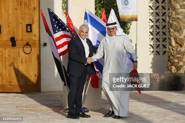 Israels Foreign Minister Yair Lapid welcomes Bahrain's Minister of Foreign Affairs Abdullatif bin Rashid al-Zayani upon his arrival for the Negev...