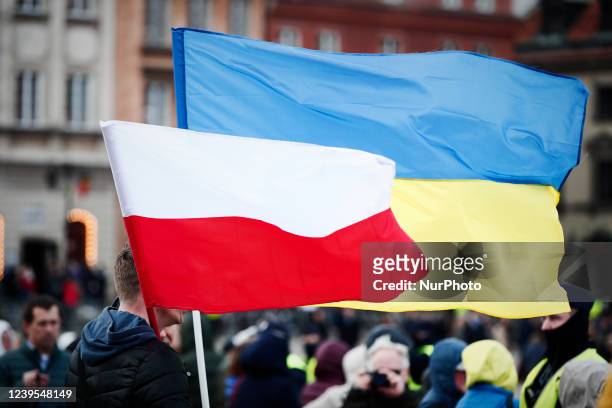 Polish and Ukrainian flags are seen in a crowd gathered to see a speech by US president Joe Biden on March 26, 2022 in Warsaw, Poland. President...