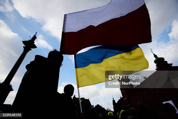 Person is seen flying Polish and Ukrainian flag near the Royal Castle ahead of a speech by US president Joe Biden on March 26, 2022 in Warsaw,...