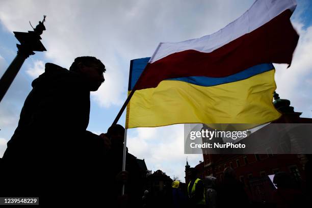 Person is seen flying Polish and Ukrainian flag near the Royal Castle ahead of a speech by US president Joe Biden on March 26, 2022 in Warsaw,...