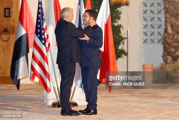Israels Foreign Minister Yair Lapid welcomes Morocco's Foreign Minister Nasser Bourita upon his arrival for the Negev Summit, at Sde Boker in the...