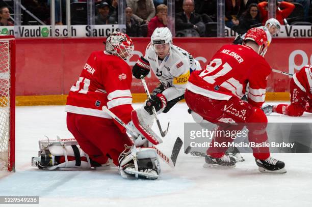 David Desharnais of HC Fribourg-Gotteron battles for the puck with Goalie Tobias Stephan and Fabian Heldner of Lausanne HC during the National League...