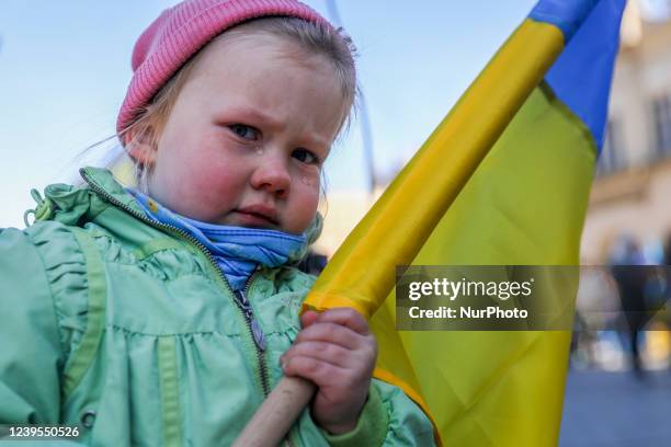 Small girl is seen crying while attending a demonstration of solidarity with Ukraine, during which 'Ode to Joy', the EU anthem, was sung in Polish...