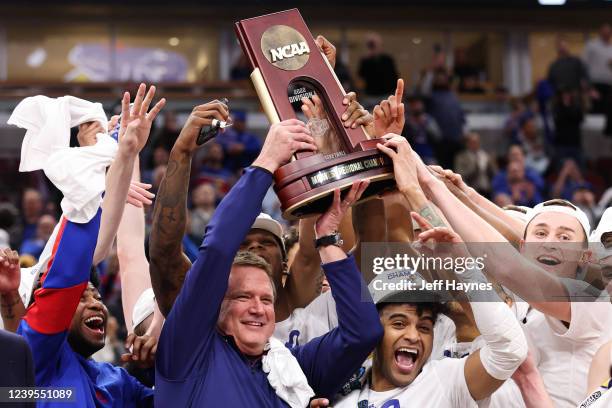 The Kansas Jayhawks hoist the Midwest Regional Champions trophy after defeating the Miami Hurricanes during the Elite Eight round of the 2022 NCAA...