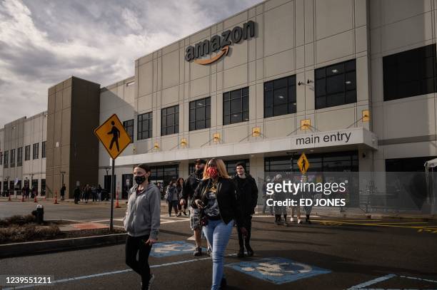 Workers walk to cast their votes over whether or not to unionize, outside an Amazon warehouse in Staten Island on March 25, 2022.