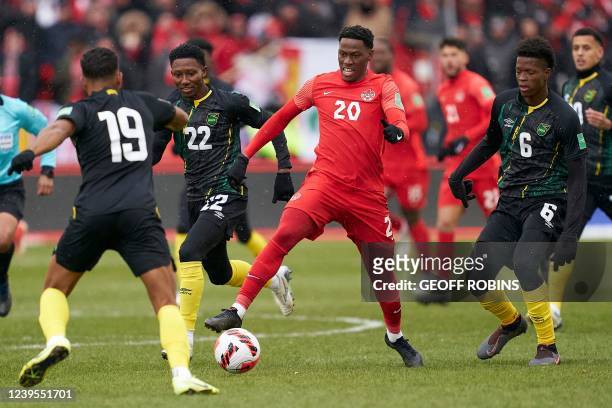 Canadas Jonathan David tries to get past Jamaicas defenders during their World Cup Qualifying match at BMO Field in Toronto, Ontario, Canada on March...