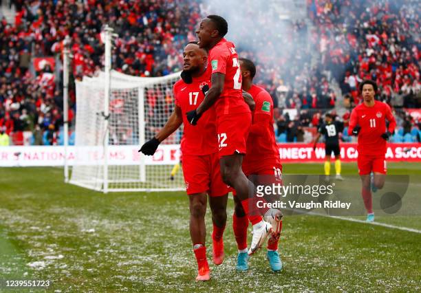 Cyle Larin of Canada celebrates a goal with Richie Laryea and Junior Hoilett during a 2022 World Cup Qualifying match against Jamaica at BMO Field on...