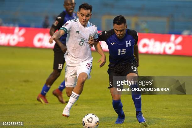 Honduras' Denil Maldonado vies for the ball with Mexico's Carlos Rodriguez during their FIFA World Cup Qatar 2022 Concacaf qualifiers football match...