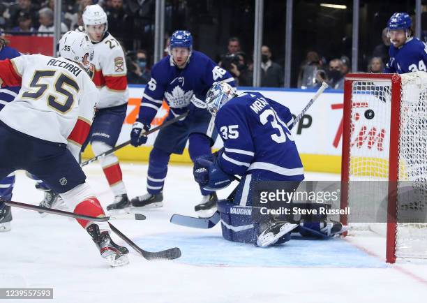 Florida Panthers center Noel Acciari watch as a shot by Florida Panthers left wing Ryan Lomberg gets past Toronto Maple Leafs goaltender Petr Mrazek...