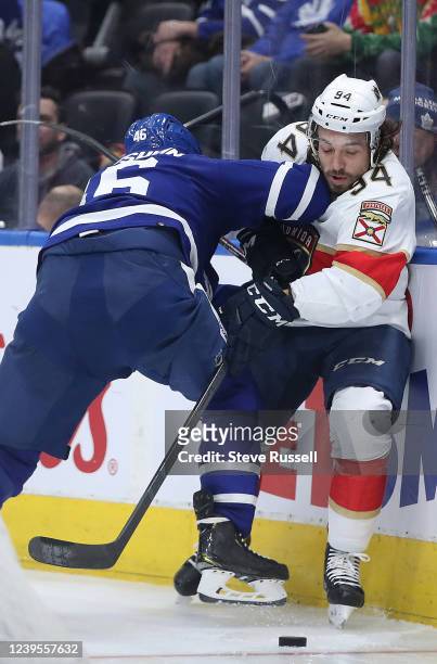 Toronto Maple Leafs defenseman Ilya Lyubushkin checks Florida Panthers left wing Ryan Lomberg as the Toronto Maple Leafs play the Florida Panthers at...
