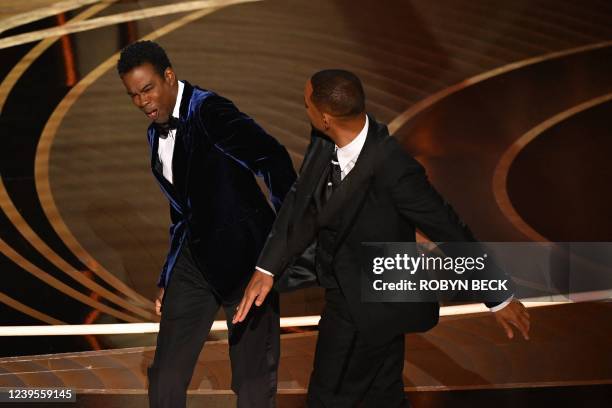 Actor Will Smith slaps US actor Chris Rock onstage during the 94th Oscars at the Dolby Theatre in Hollywood, California on March 27, 2022.