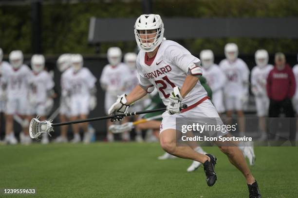 Harvard Crimson long stick midfielder Greg Campisi runs with the ball during a college lacrosse game between the Dartmouth Big Green and Harvard...