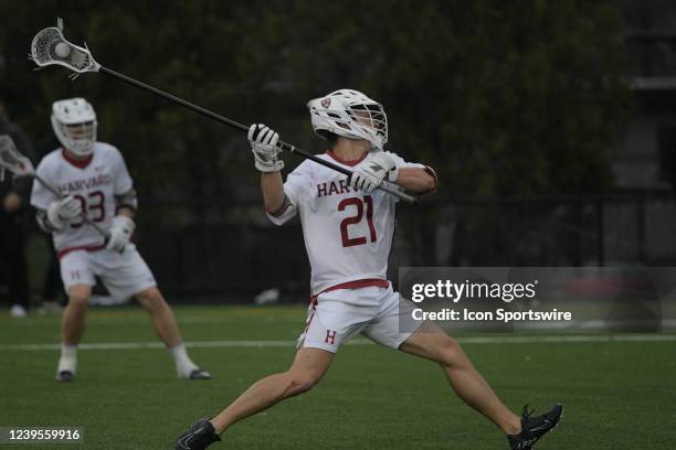 Harvard Crimson long stick midfielder Greg Campisi passes the ball during a college lacrosse game between the Dartmouth Big Green and Harvard Crimson...