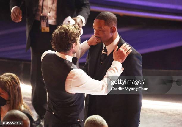 March 27, 2022. Bradley Cooper comforts Will Smith during the show at the 94th Academy Awards at the Dolby Theatre at Ovation Hollywood on Sunday,...