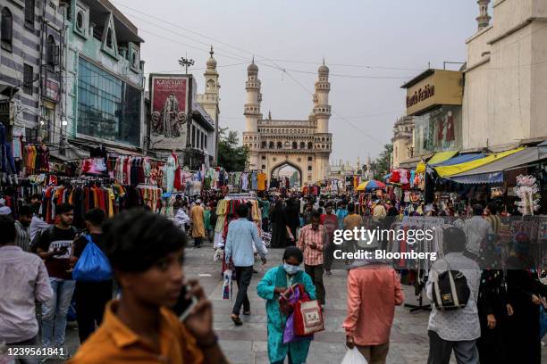 Shoppers walk through a market in the Charminar area in Hyderabad, India, on Wednesday, March 23, 2022. Indias urban consumption is driving recovery...