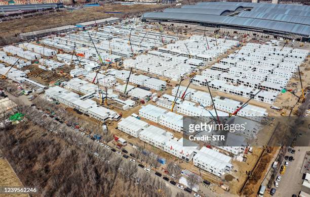 This aerial photo taken on March 27, 2022 shows the construction of a temporary field hospital in Shenyang in China's northeastern Liaoning province....