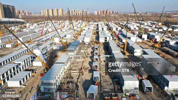 This aerial photo taken on March 26, 2022 shows the construction of a temporary field hospital in Shenyang in China's northeastern Liaoning province....