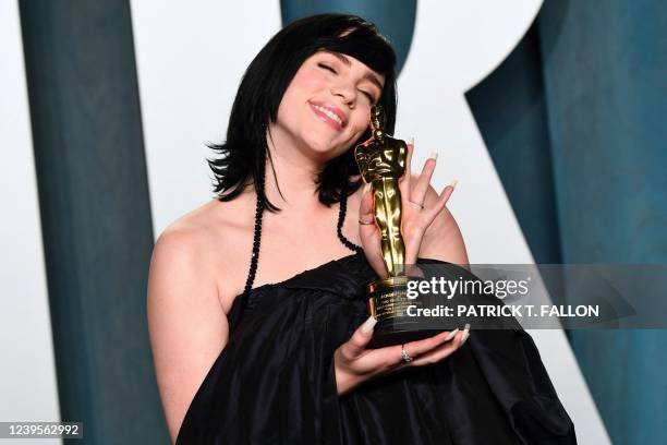 Singer-songwriter Billie Eilish holds the award for Best Music for "No Time to Die" as she attends the 2022 Vanity Fair Oscar Party following the...