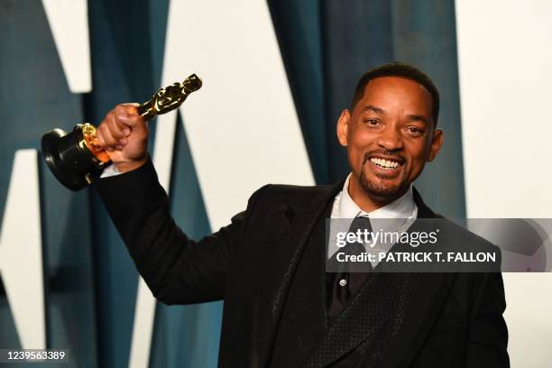 Actor Will Smith holds his award for Best Actor in a Leading Role for "King Richard" as he attends the 2022 Vanity Fair Oscar Party following the...