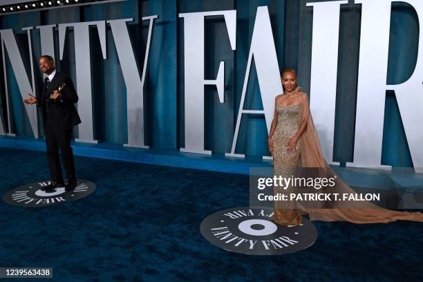 Actor Will Smith holds his award for Best Actor in a Leading Role for "King Richard" alongside wife Jada Pinkett Smith as they attend the 2022 Vanity...