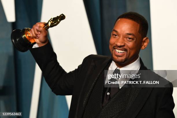 Actor Will Smith holds his award for Best Actor in a Leading Role for "King Richard" as he attends the 2022 Vanity Fair Oscar Party following the...