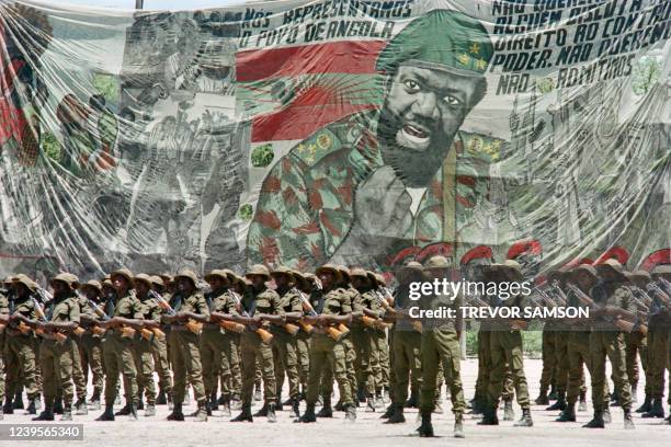 Soldiers of National Union for the Total Independence of Angola parade under the effigy of Jonas Savimbi, on December 11, 1985 at Luanda during the...