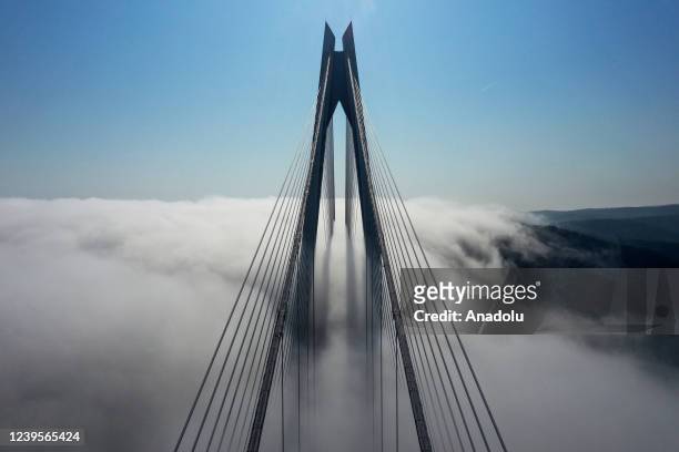 An aerial view of fog covering the city and Yavuz Sultan Selim Bridge during morning hours in Istanbul, Turkiye on March 28, 2022.